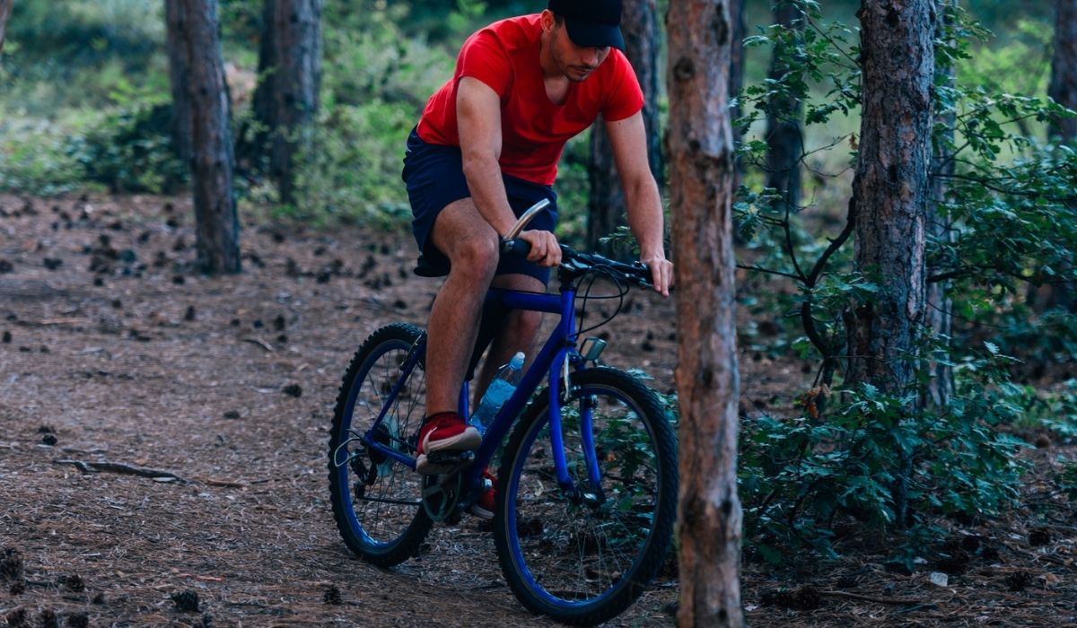 Fit cyclist riding his bike downhill through