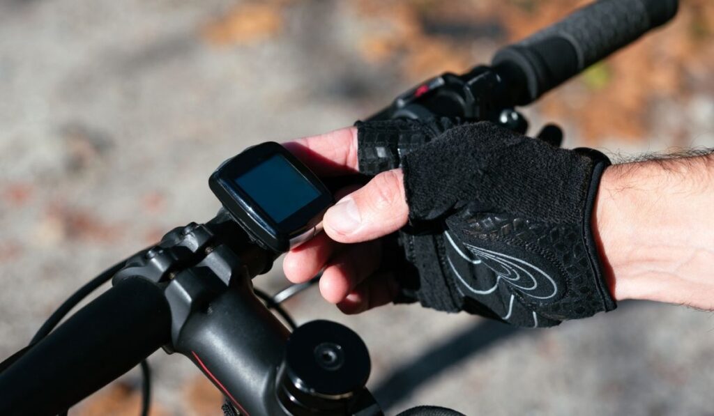 High angle shot of a cyclist adjusting his bike s GPS
