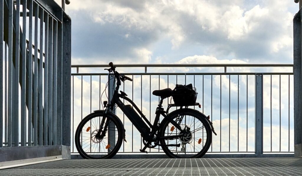Electric bicycle on a skywalk with dramatic sky in the background