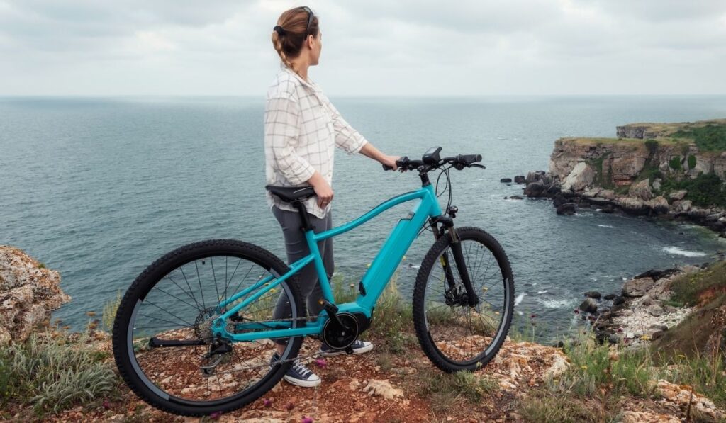 Woman with a bike in the nature