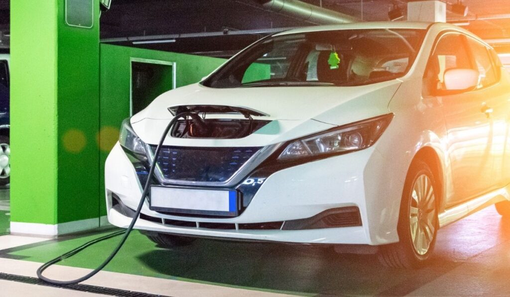 Electric car charge battery on eco energy charger station